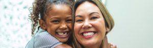 woman with little girl riding piggy back