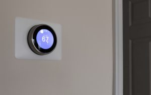 Smart thermostat on wall of home