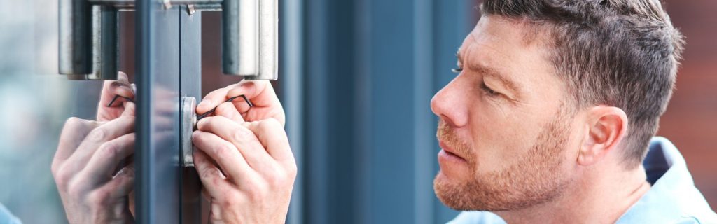 man installs door lock