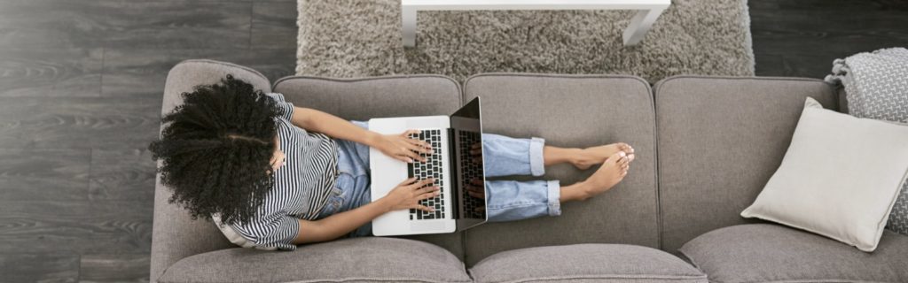 Woman using laptop computer on couch