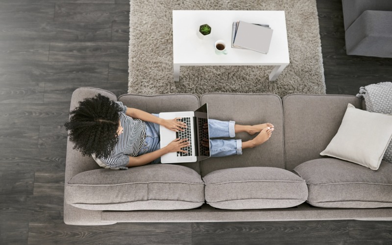 Woman using laptop computer on couch