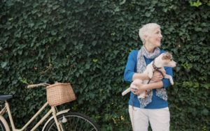older woman with dog and bike