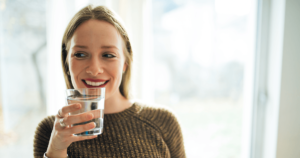 smiling woman with a glass of water