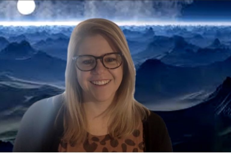 Zoom screenshot of woman in front of moonscape background