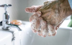 older man washing his hands