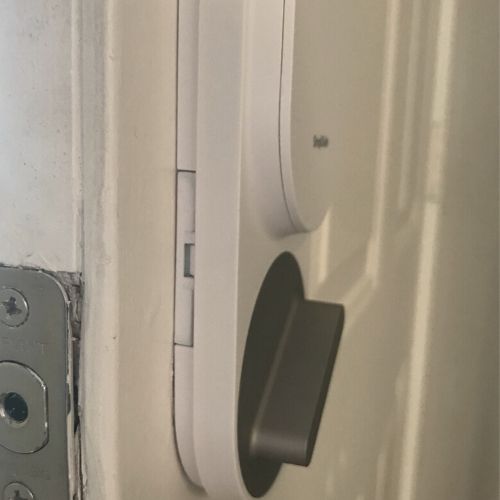 Side view of the simplisafe door lock mounted on a door