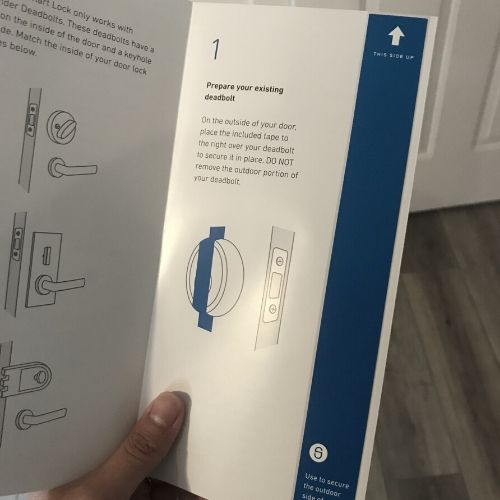 hand holding written instructions to install simplisafe lock