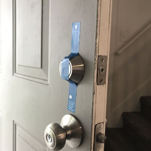 deadbolt held in place with blue tape