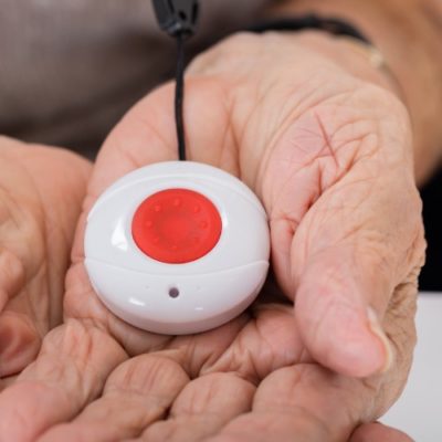 medical alert button in woman's hand