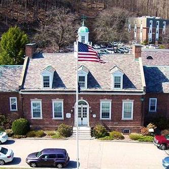 Brick building with flag in front in Bedford Town, NY