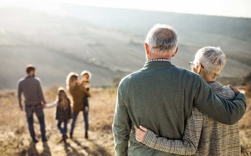 older couple watching their family