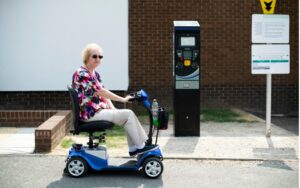 older woman using a mobility scooter