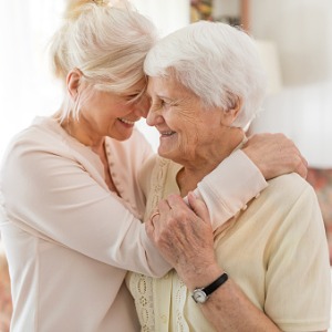 woman embracing senior mother