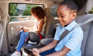 kids using devices while sitting in booster seats