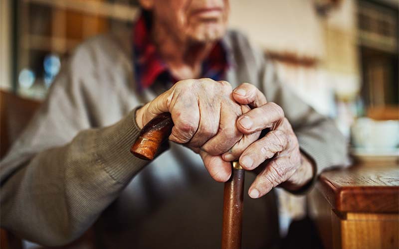 senior man holding a cane