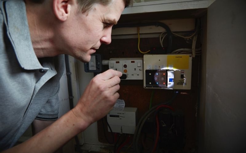 Man checks fuses box in a blackout