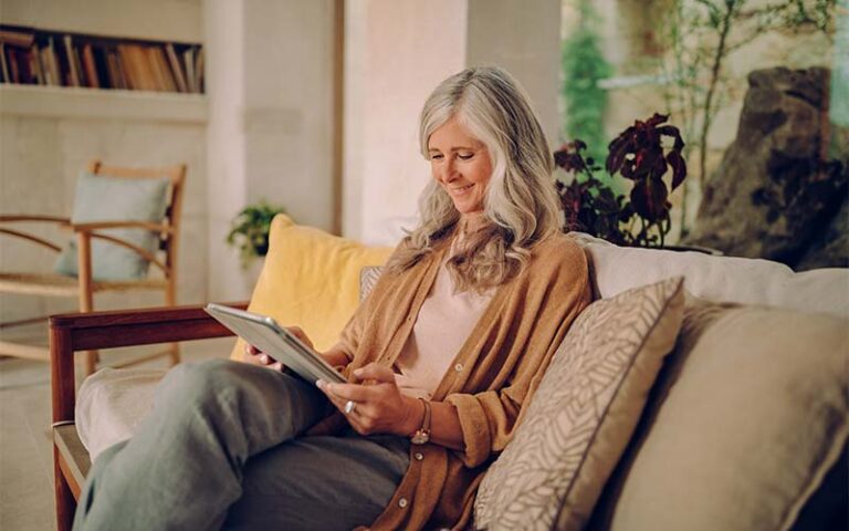 featured-elderly-woman-using-tablet-on-couch