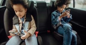 kids in booster seats on cell phones