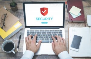 man typing on computer with antivirus