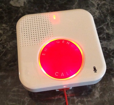 The GetSafe voice-activated wall button's status light blinks red during one of senior safety expert Cathy Habas's test calls.