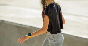 Skateboarding Girl Wearing Smart Watch While Riding