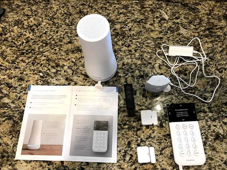 The SimpliSafe home security kit laid out on a granite countertop