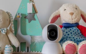 nanny camera on shelf with stuffed animals
