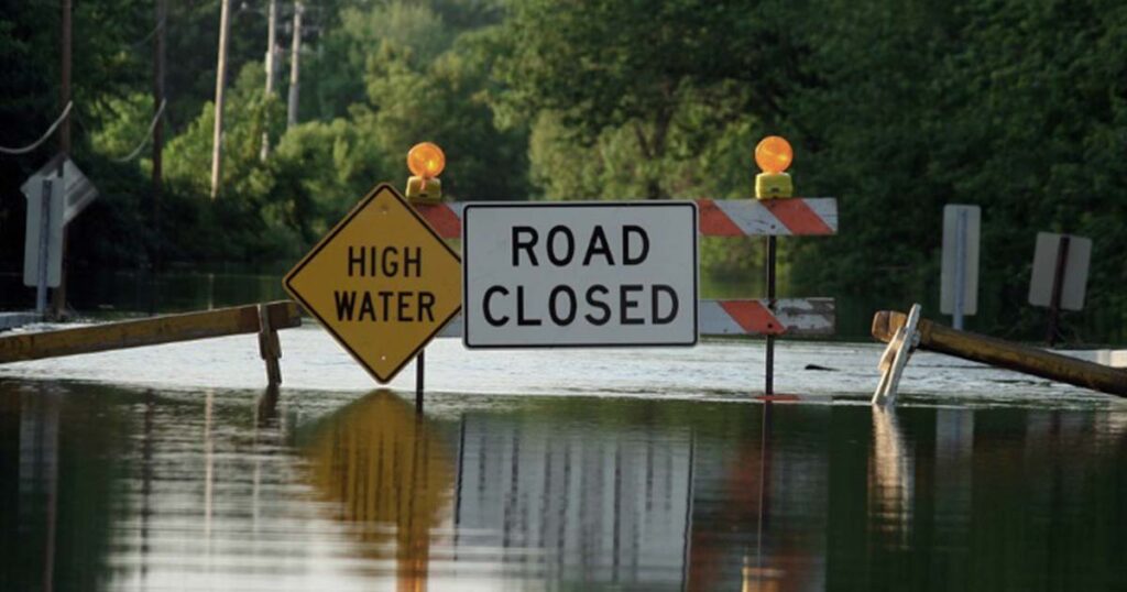 warning signs on flooded road