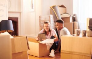 Young couple looking through moving boxes