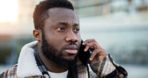man with worried face making phone call