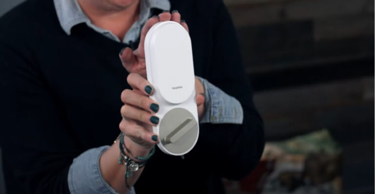 Home security and safety expert Rebecca Edwards holding the SimpliSafe Smart Lock.