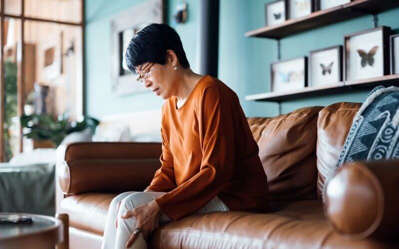 Woman with aching knee