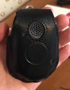 A close-up of the Bay Alarm Medical Mobile GPS button inside the belt holster.