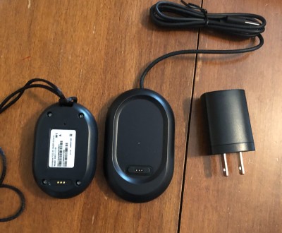 The Bay Alarm Medical Mobile GPS button and charger, showing the matching prongs.