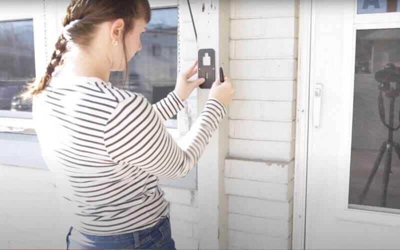 Katie McEntire installs a Kami Doorbell backplate