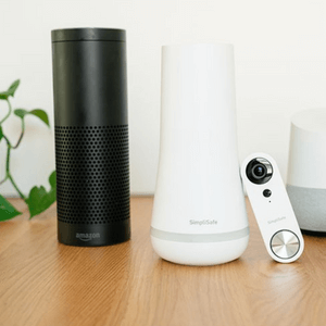 SimpliSafe hub and Alexa device on a table with a SimpliSafe doorbell