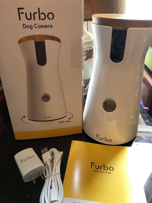 Furbo dog camera next to box and accessories