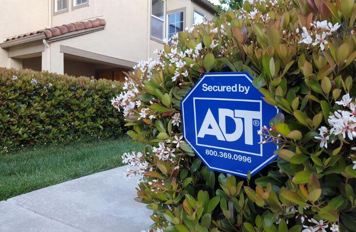 adt yard sign in bushes