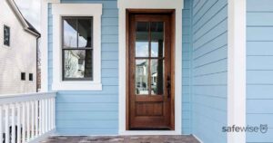 blue house and brown wooden door