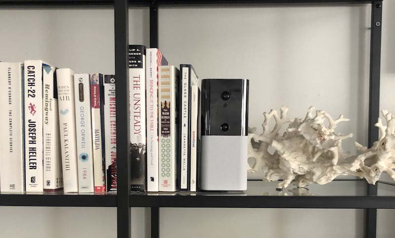 abode iota on shelf next to books