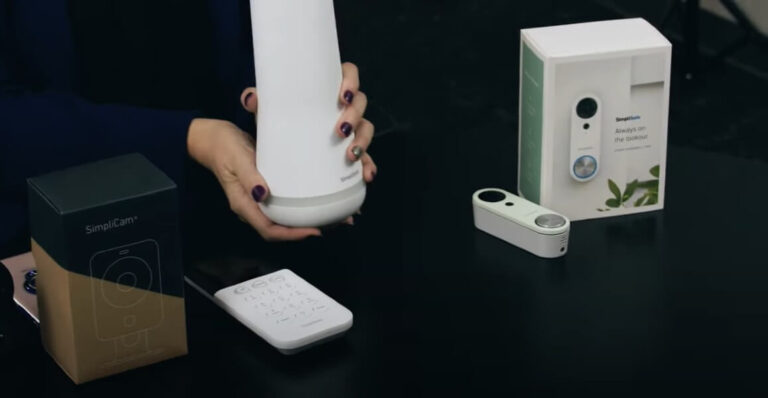 person holding simplisafe equipment