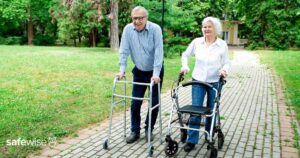 two-seniors-walking-with-walkers-outdoors (1)