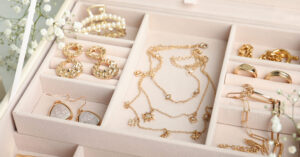 Different elegant bijouterie in pink jewelry box, closeup