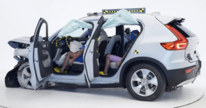 A driver and back-seat crush test dummy sit in a 2021 Volvo XC40 post-crash test.