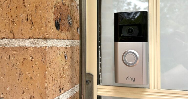 Ring Video Doorbell 4 attached to a window next to a front door