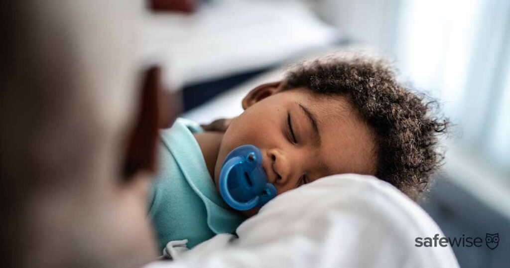 small kid sleeping with pacifier