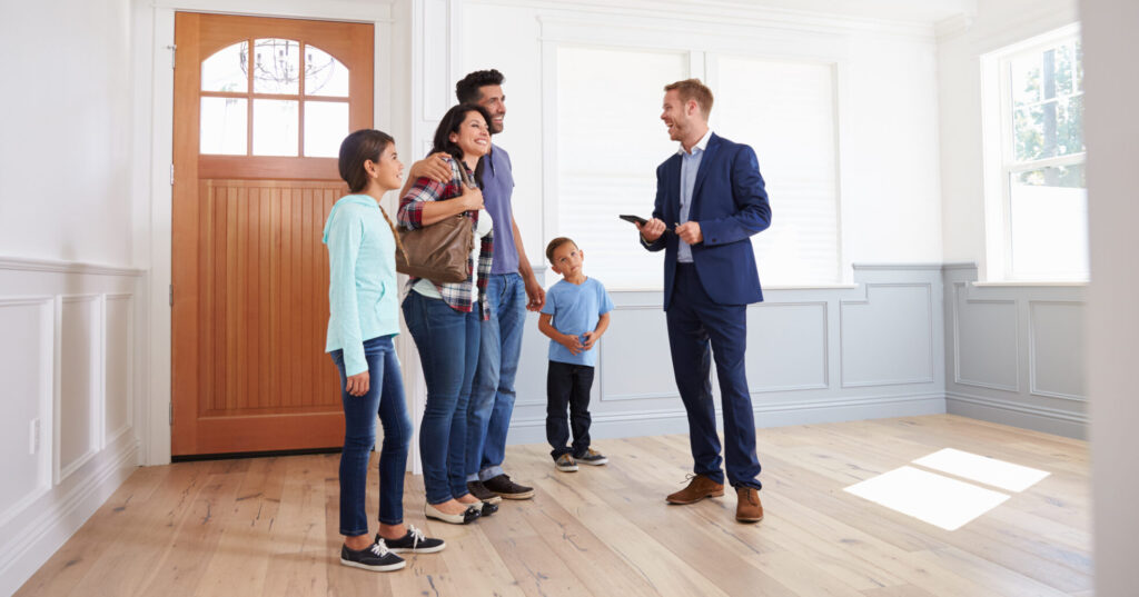 Realtor Showing Hispanic Family Around New Home