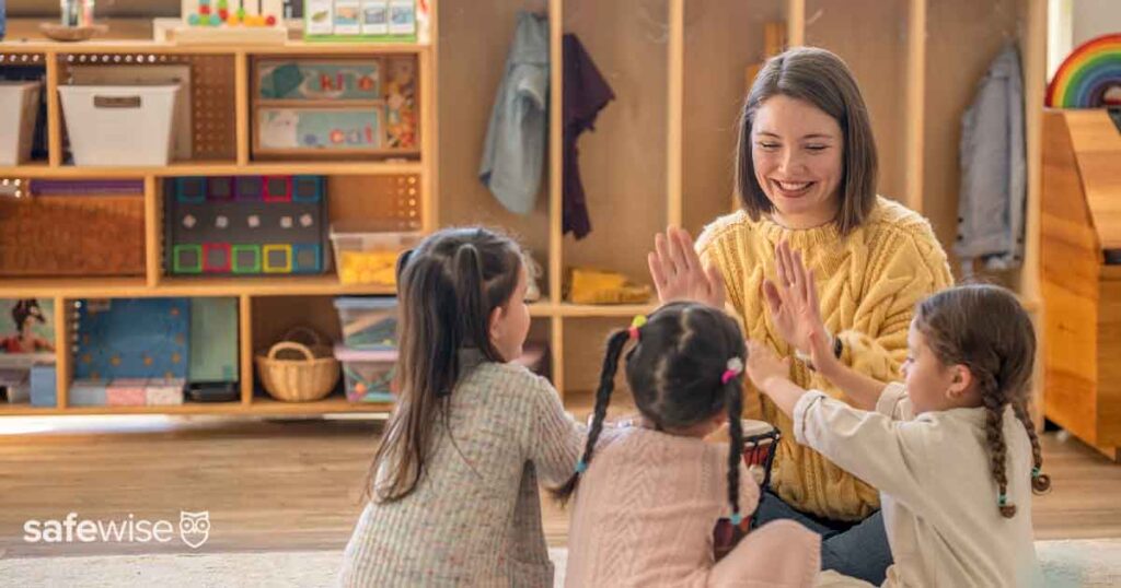 daycare worker sitting with children