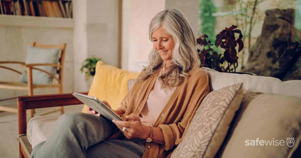 elderly-woman-using-tablet-on-couch