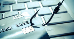 credit card phishing - piles of credit cards with a fish hook on